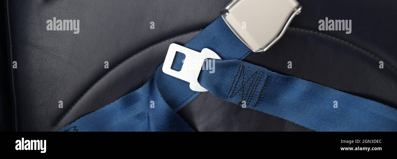 Safety belts lying on passenger seat of aircraft closeup Stock Photo