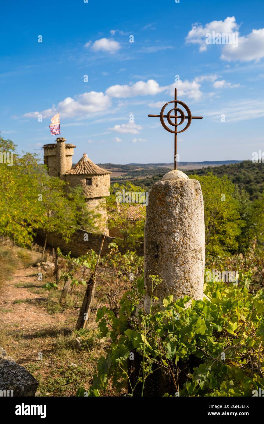 detail cross in mound with double medieval tower with stone wall 