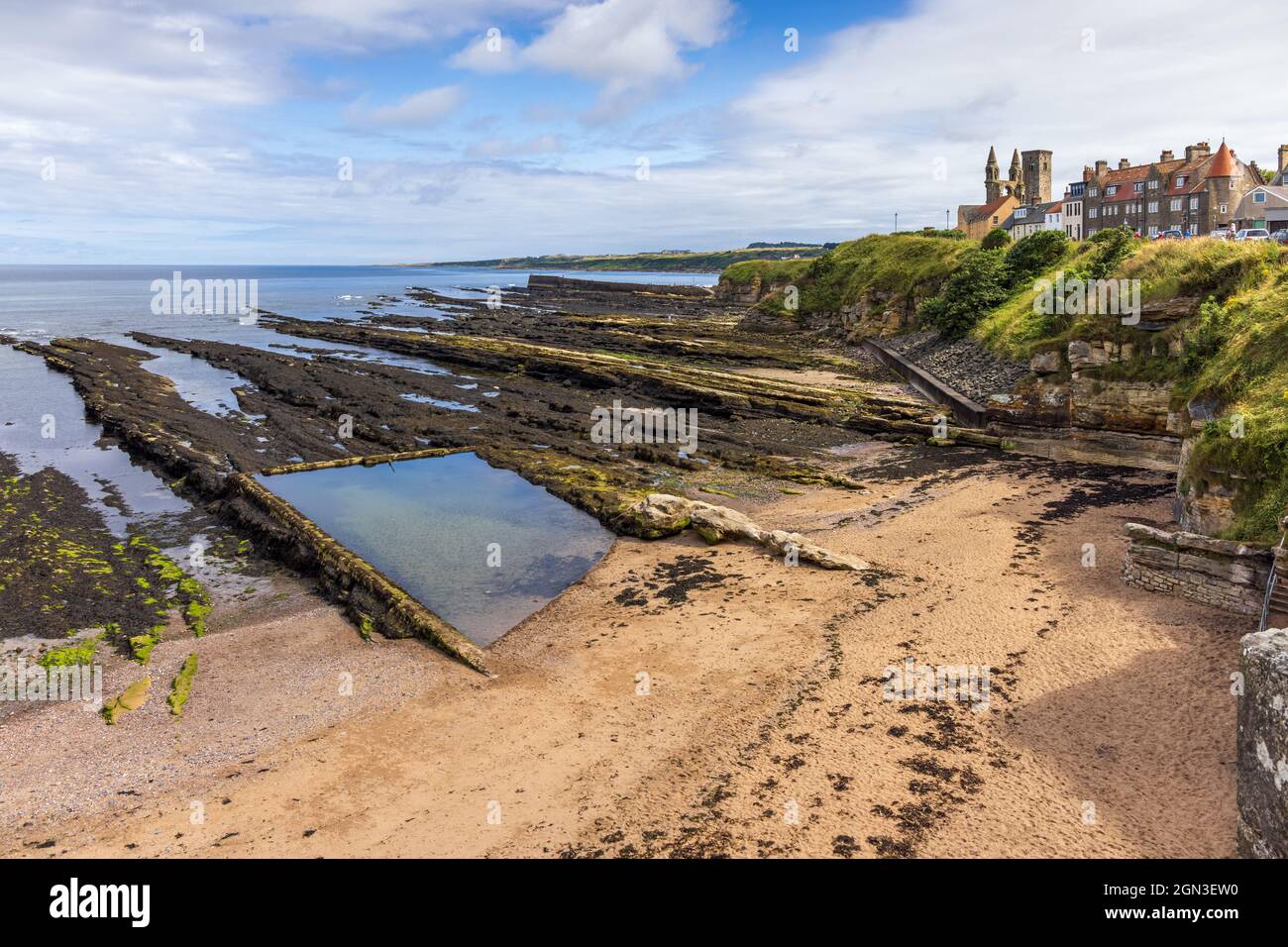 Castle Sands and the old bathing pool at St Andrews in Fife, with the Cathedral and St. Rule's Tower in the distance. Stock Photo