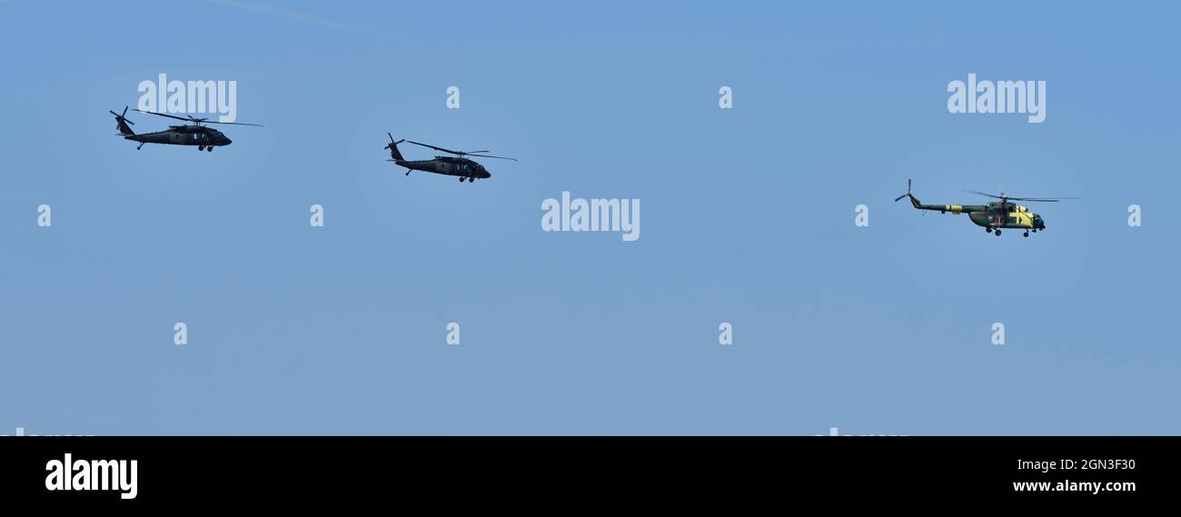 Three helicopters in a row during the flight Stock Photo