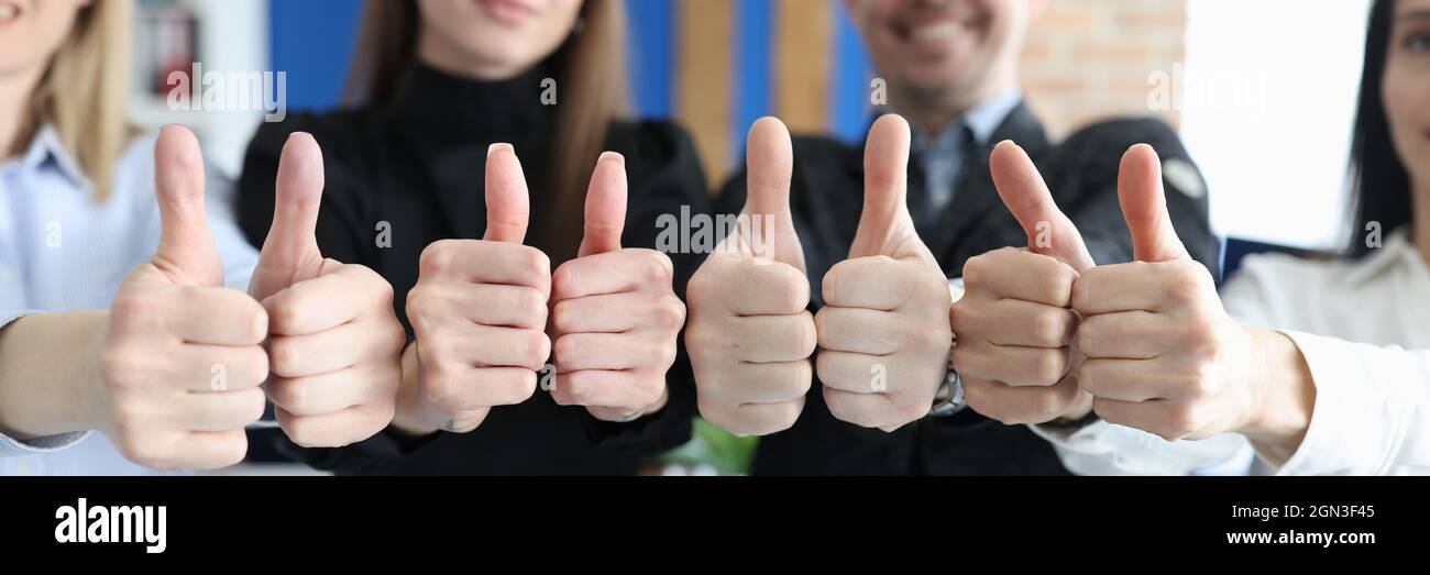 Group of business people showing thumb up in office closeup Stock Photo ...