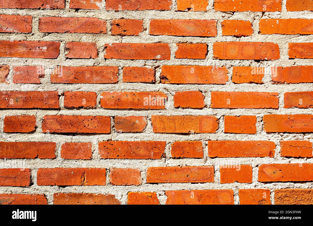 Old weathered red brick wall as background Stock Photo
