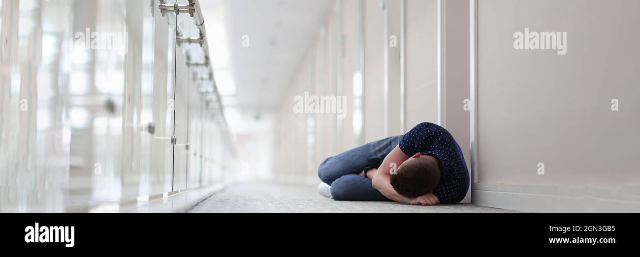 Young man sleeping under closed door of hotel room Stock Photo Alamy