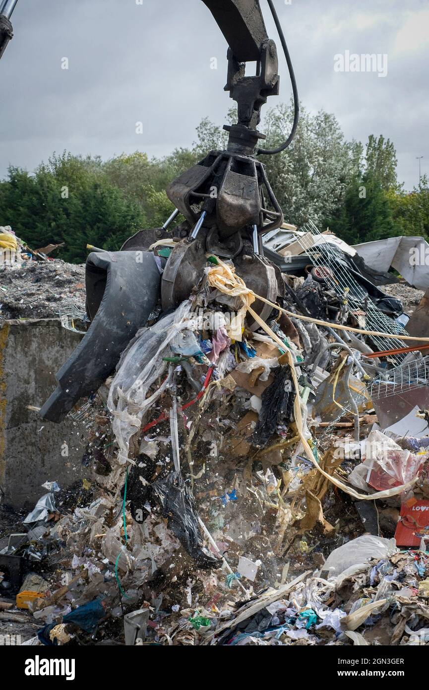 Hydraulic grabber machine being used at a materials recovery facility in England. Stock Photo