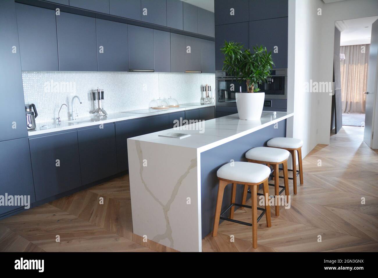 Modern kitchen interior design with hardwood floors in luxury home Stock Photo