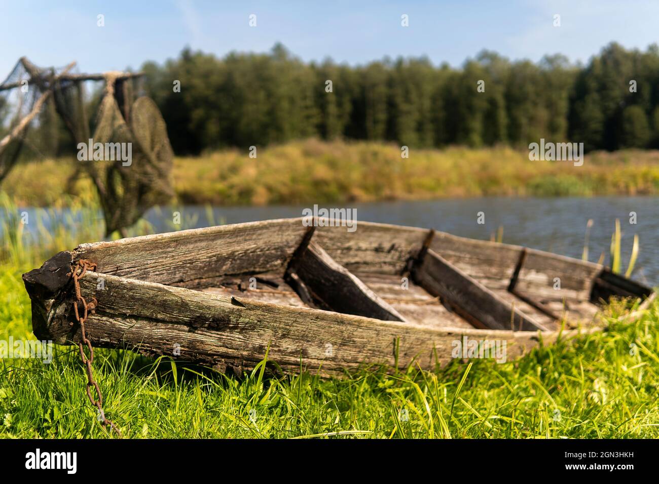 old wooden boat to the shore of the lake on a sunny day Stock Photo - Alamy