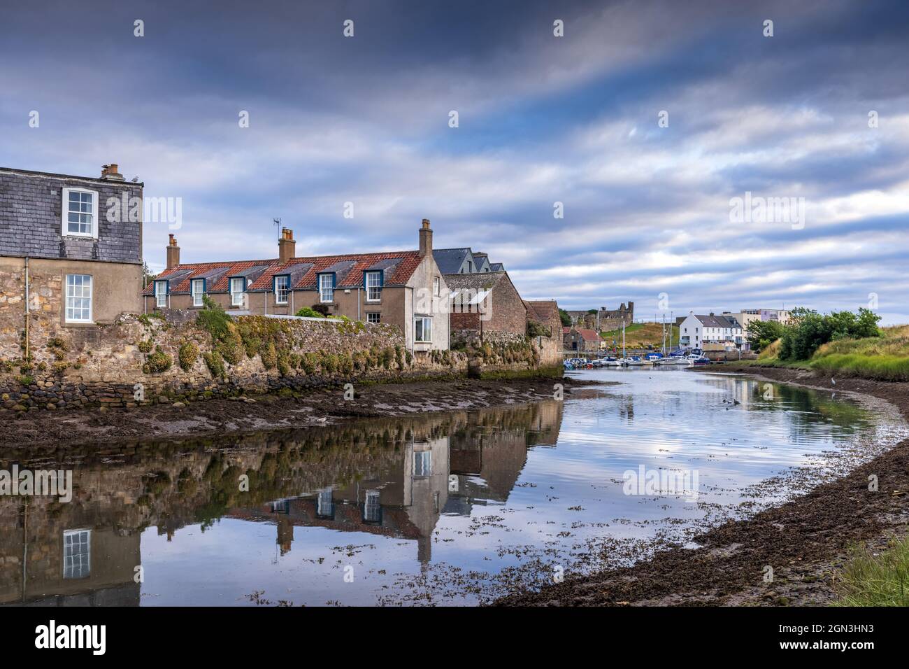 Reflections in Kinness Burn in St Andrews, with the harbour and cathedral ruins in the background, East Neuk, Fife, Scotland. Stock Photo