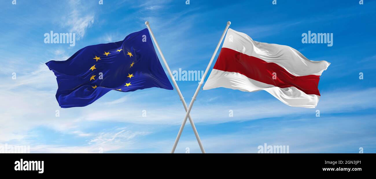 flags of European Union and Belarus waving in the wind on flagpoles ...