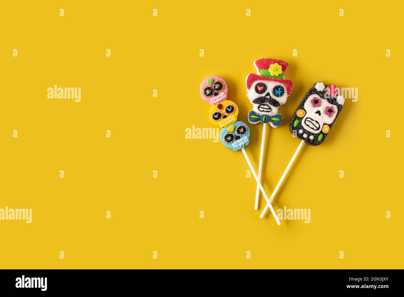 Candy skull lollipops on yellow background Stock Photo