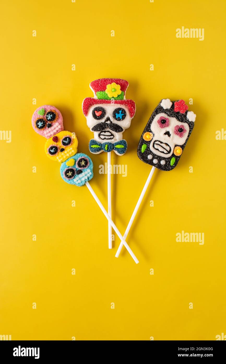 Candy skull lollipops on yellow background Stock Photo