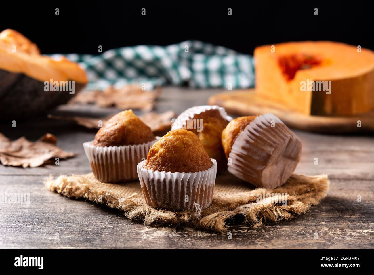 Pumpkin muffins on wooden table Stock Photo
