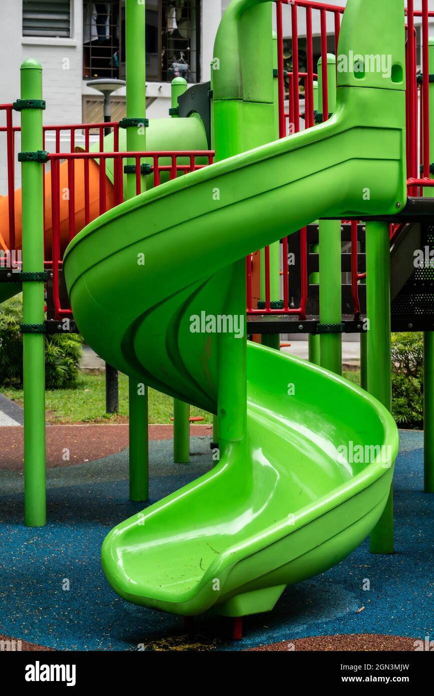 Green kids curve slide Stock Photo Alamy
