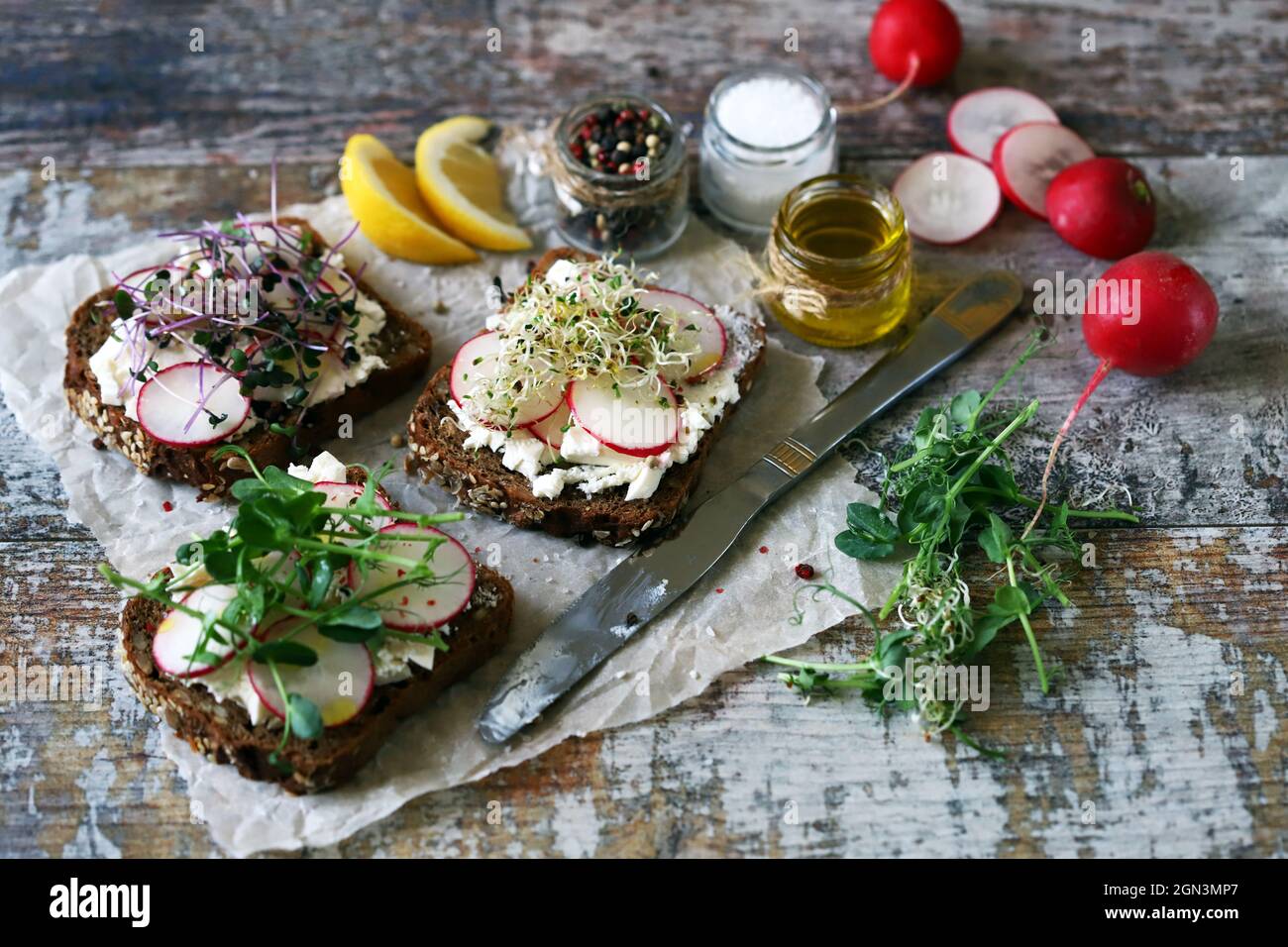 Healthy toasts with white cheese radish and microgreens. Keto diet. Keto toasts. Organic food. Super food. Stock Photo