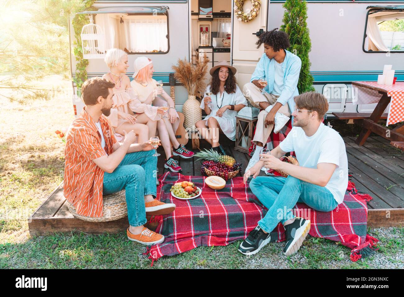 Friends have a picnic with a camper in a sunny day Stock Photo