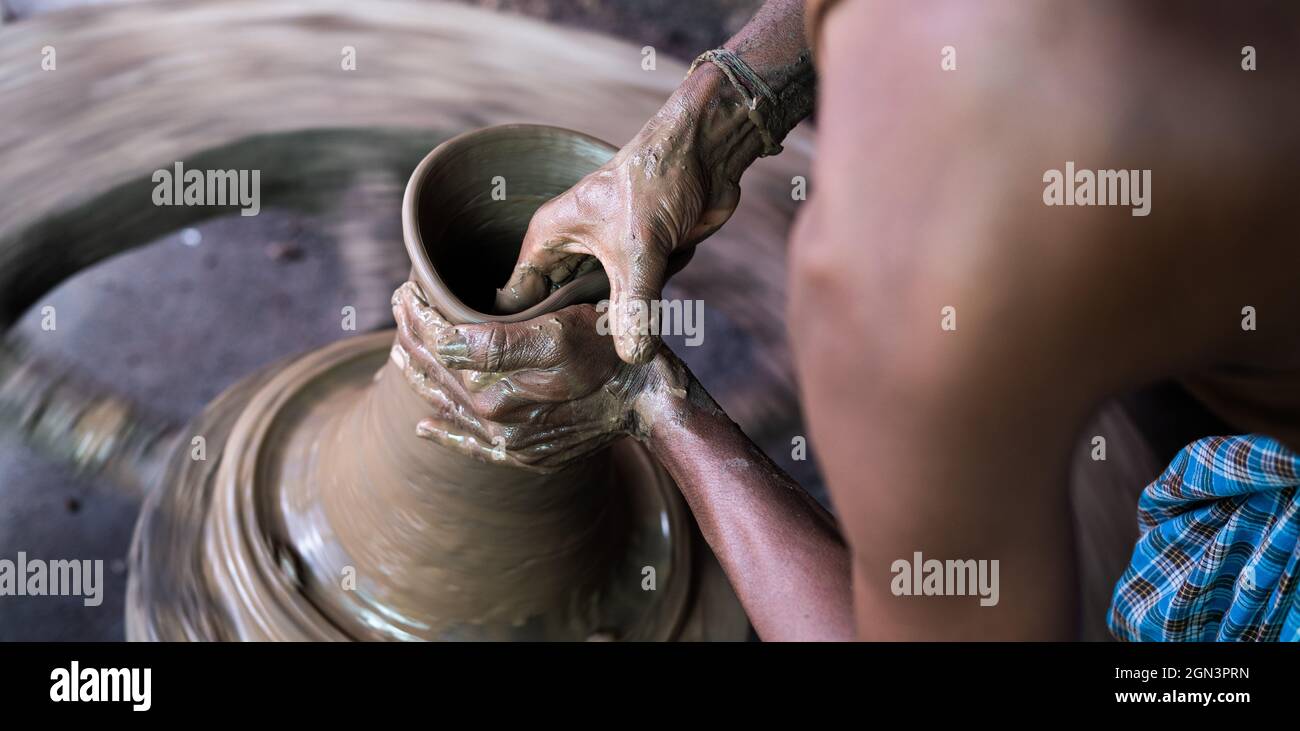 Shoulder shot of potter molding clay pot to create form concept of hobby, artist, and leisure