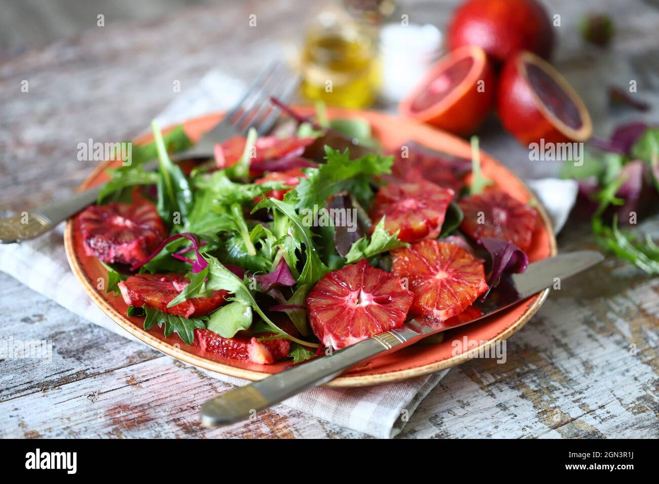 Super nutritious detox salad with red orange and mix of salads. Vegan diet. Diet food. Fitness nutrition. Stock Photo