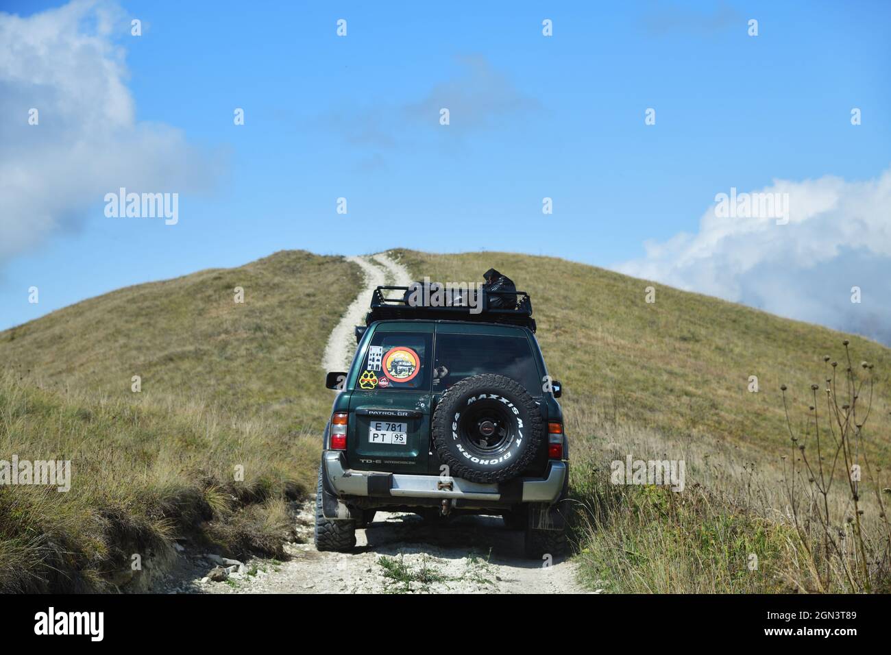 Chechnya, Russia - Sept 12, 2021: Off-road car shown in the Caucasus mountains landscape. Vedeno district of the Chechen Republic. Extreme mountain sa Stock Photo