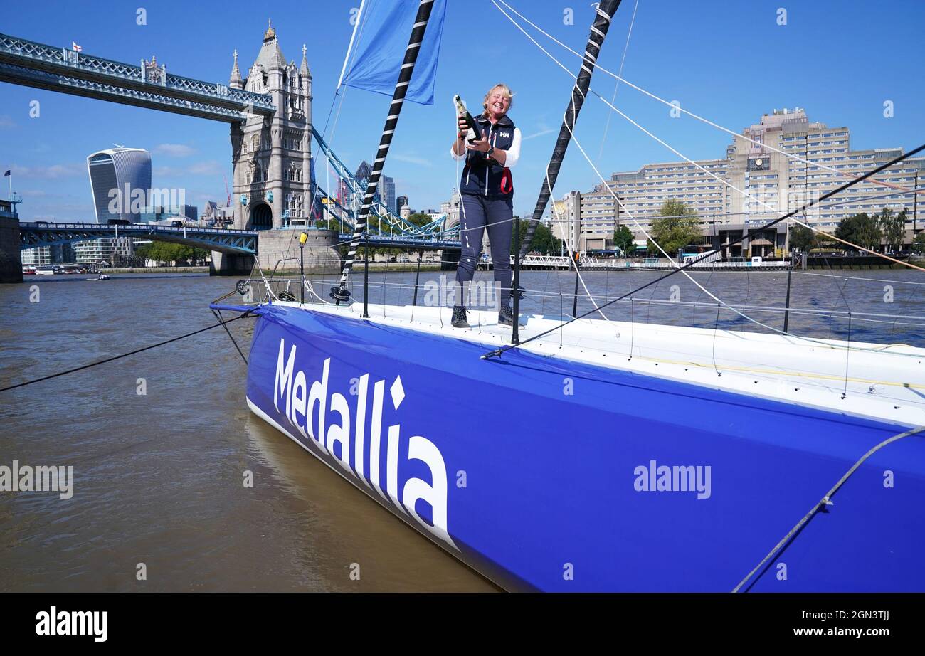Sailor Pip Hare pours champagne during the official naming of her new