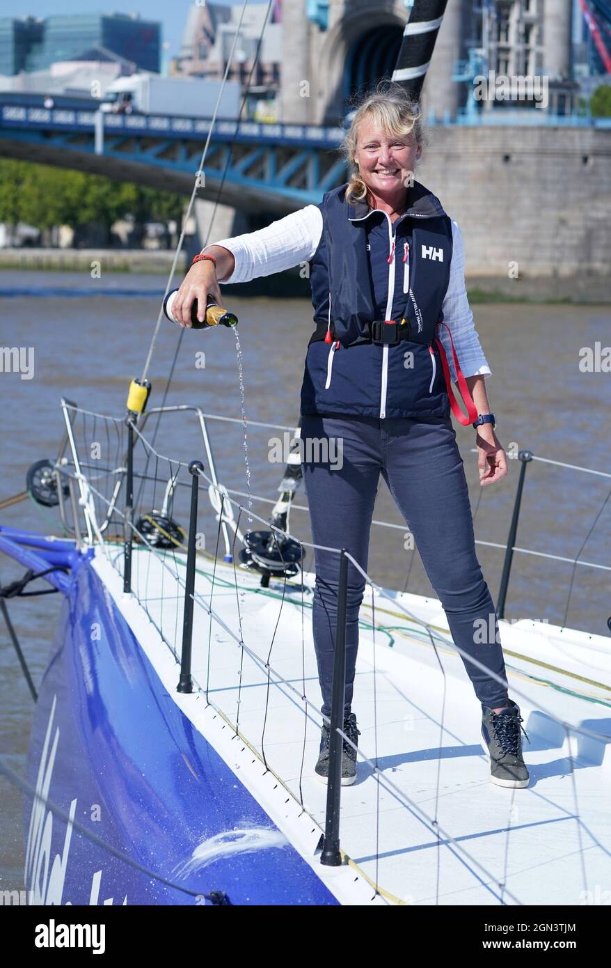 Sailor Pip Hare pours champagne during the official naming of her new
