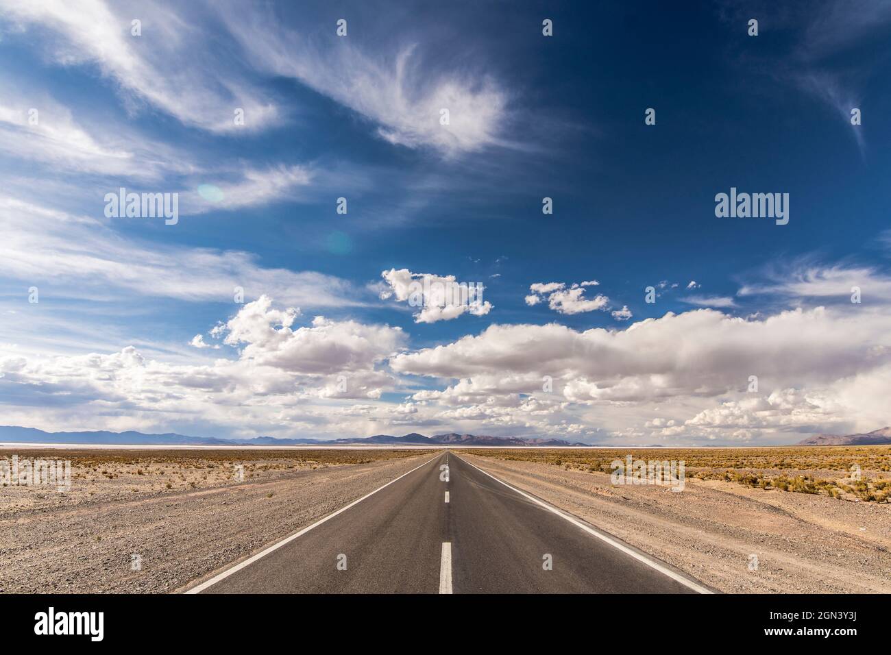 Centered road middle POV in a salt field. Salinas Grandes, Jujuy, Argentina. Symmetrical landscape photography. Stock Photo
