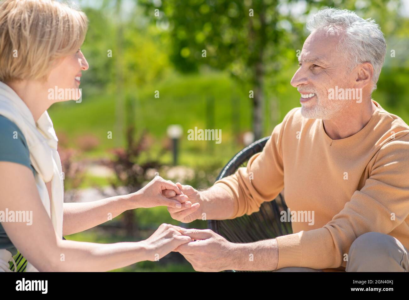 Two middle-aged people in love looking at each other Stock Photo