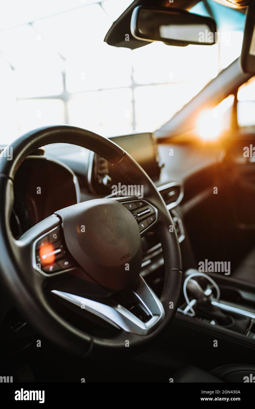 Luxury car interior steering wheel, shift lever and dashboard Stock
