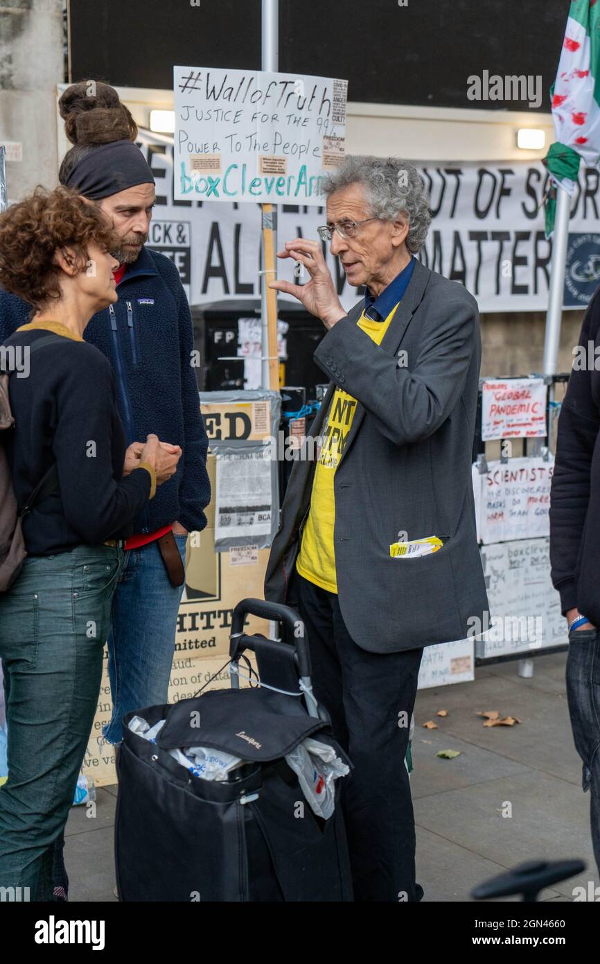 Piers Corbyn, the brother of former Labour Party leader Jeremy Corbyn, seen talking with protesters during an anti-vaccination, anti-lockdown protest outside Downing Street.Anti-vaccination and anti-lockdown protesters demonstrate outside Downing Street as the Prime Minister Boris Johnson carries out a reshuffle of his Cabinet. Stock Photo