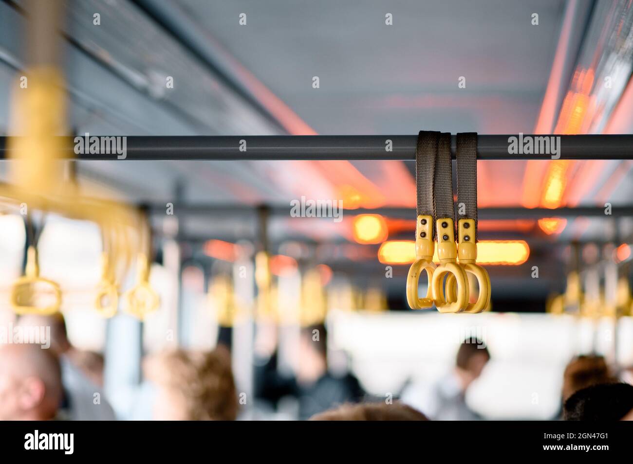 Hanging handhold for standing passengers in a modern train. Suburban and urban transport Stock Photo