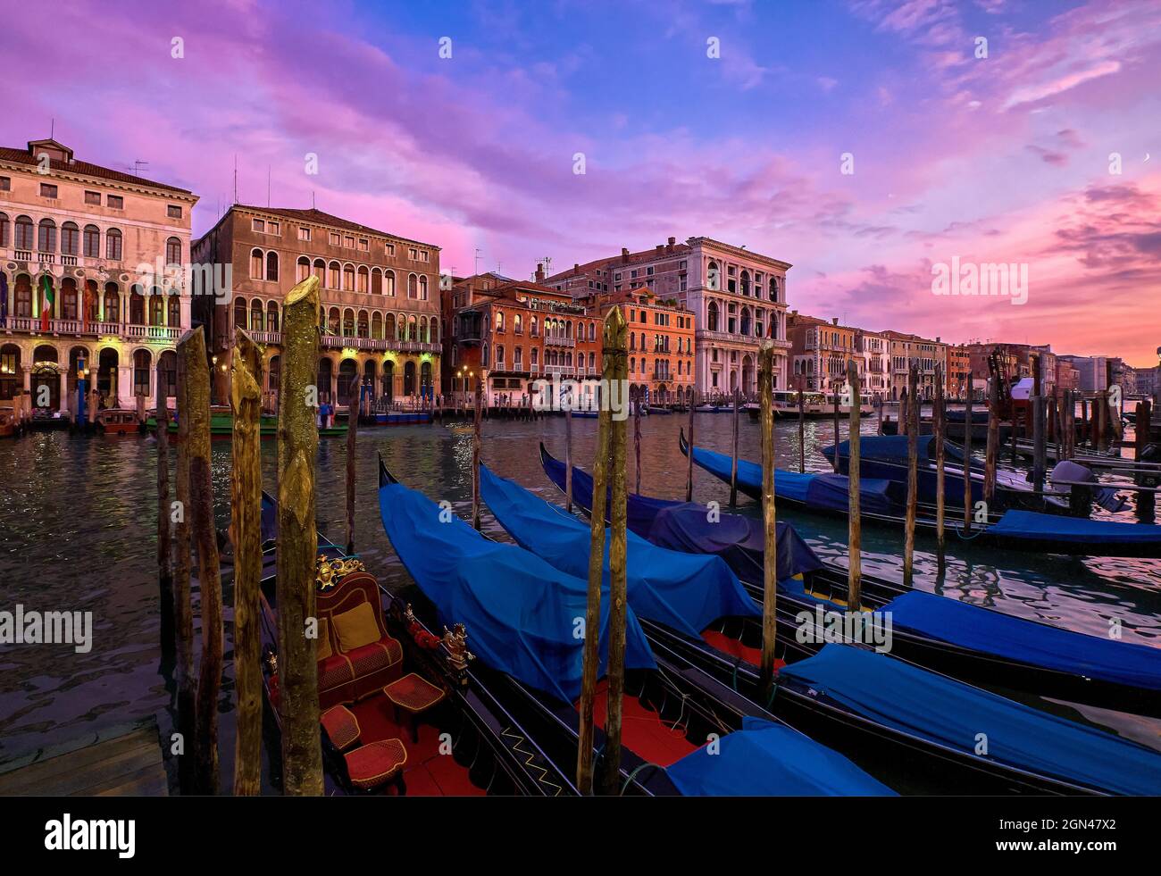 Sunset view of Grand Canal, Venice, Italy. UNESCO heritage city famous for its waterways and gondolas, beautiful sunset sky and evening lights Stock Photo