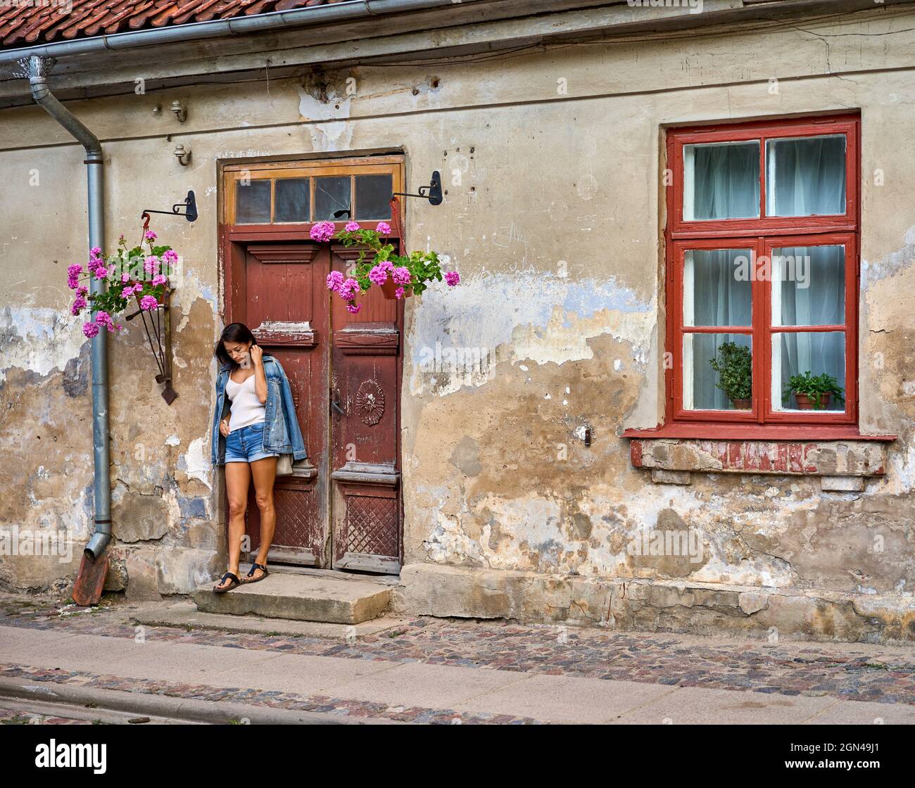 Old wooden doors of house with girl hi-res stock photography and images ...