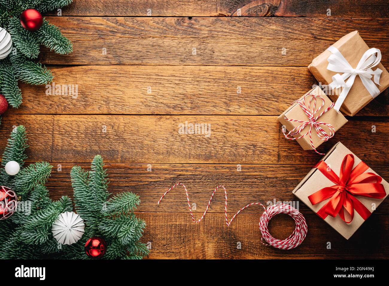 Christmas Frame Background With Fir Tree, Presents On Old Wooden Planks Background, Top View Copy Space For Text, Invitation Card, Greeting Stock Photo