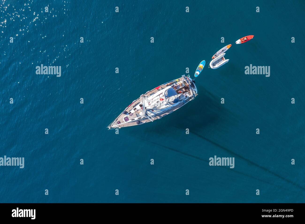 Aerial view to small yacht in a deep blue sea Stock Photo - Alamy