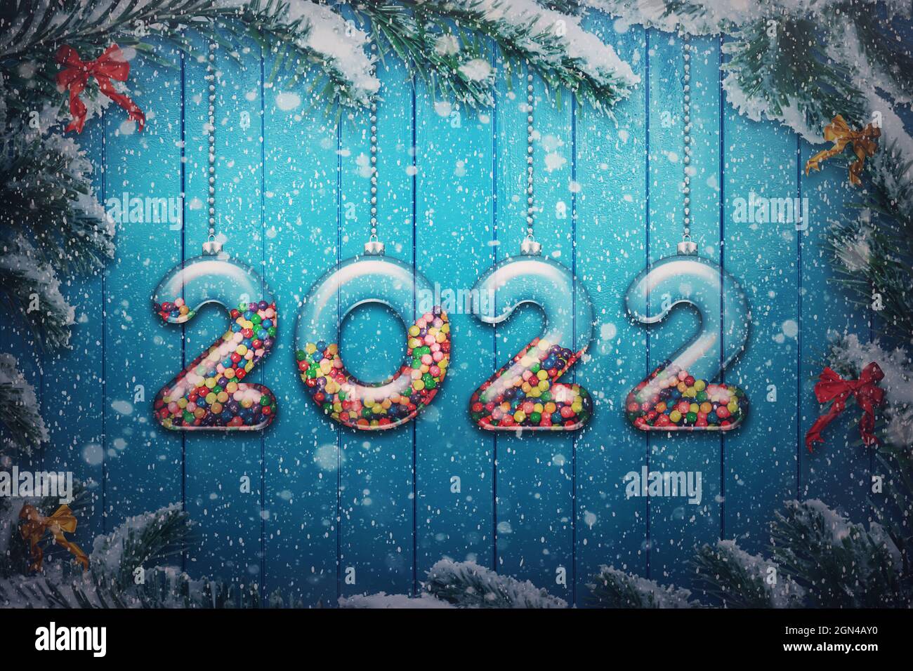 Christmas 2022 Candy Happy New Year 2022 Holiday Background. Set Of Transparent Numbers Made Of  Glass Filled With Multi Colored Candy And Sweets Hang On Snowy Christmas Tr  Stock Photo - Alamy