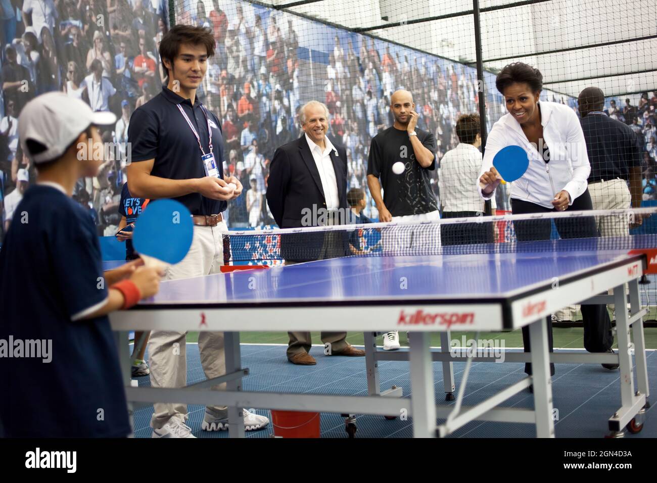 First Lady Michelle Obama plays table tennis during a Let's Move! event at the USTA Billie Jean King National Tennis Center in New York, N.Y., Sept. 9, 2011. (Official White House Photo by Samantha Appleton) This official White House photograph is being made available only for publication by news organizations and/or for personal use printing by the subject(s) of the photograph. The photograph may not be manipulated in any way and may not be used in commercial or political materials, advertisements, emails, products, promotions that in any way suggests approval or endorsement of the President, Stock Photo