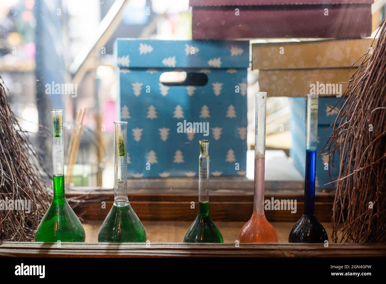 Chemistry laboratory. Conducting a chemical experiment. Experiments in the laboratory. Flasks and test tubes with colored liquid. The child conducts Stock Photo