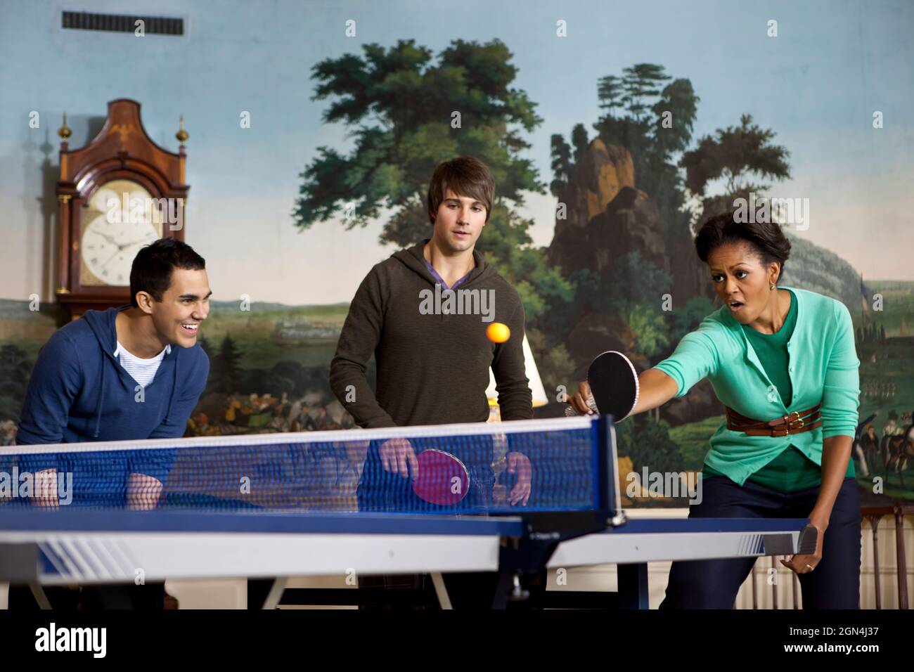 First Lady Michelle Obama plays table tennis with members of the band Big  Time Rush in the Diplomatic Reception Room of the White House during a  taping for NIckelodeon's Worldwide Day of