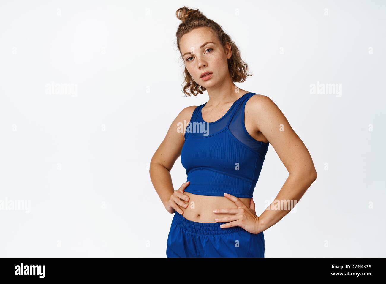 Portrait of motivated and confident sports woman, hold hands on waist,  wearing sportswear. Fitness girl workout, stands isolated on white  background Stock Photo - Alamy