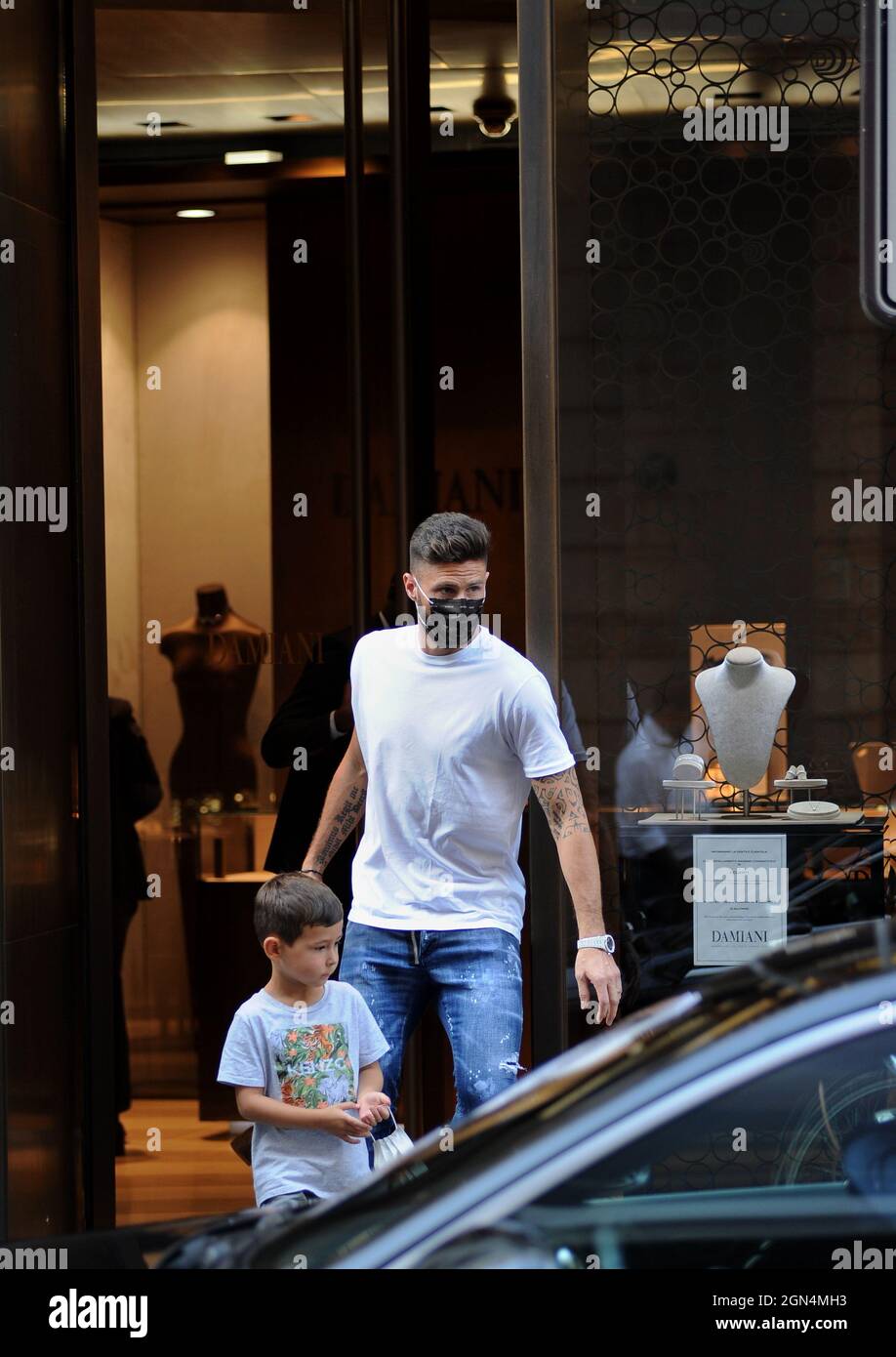 Milan, . 22nd Sep, 2021. Milan, 22-9-2021 Olivier Giroud, striker of Milan and the French national team, surprised in the center together with his son AAron - First they go to CHANEL, Olivier Giroud queues up and waits for his turn because he enters a little at a time But then many minutes pass and he decides to go to 'DAMIANI', the prestigious jewelry store in via Montenapoleone, to buy a bracelet and a necklace to give to his wife JENNIFER. When he leaves, he walks towards the parking lot to pick up his Ferrari and go home. EXCLUSIVE SERVICE Credit: Independent Photo Agency/Alamy Live News Stock Photo
