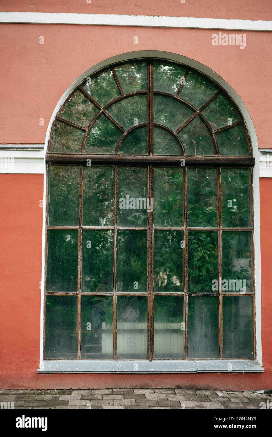 Small pink house with a large arched window Stock Photo