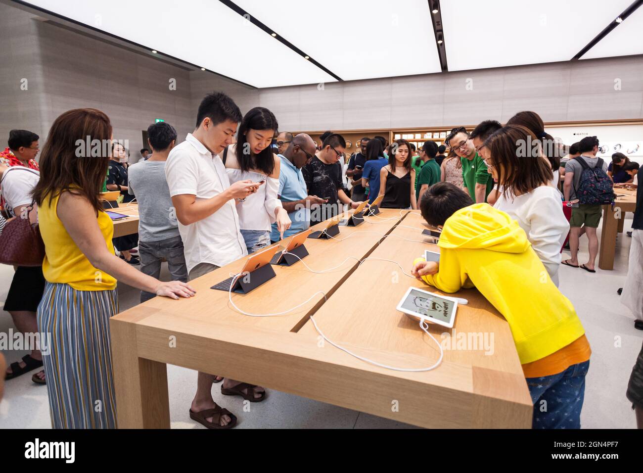 SINGAPORE - MAY 28, 2017: People check the latest ipads in the new Apple Store at Orchard Road on May 28, 2017 Stock Photo