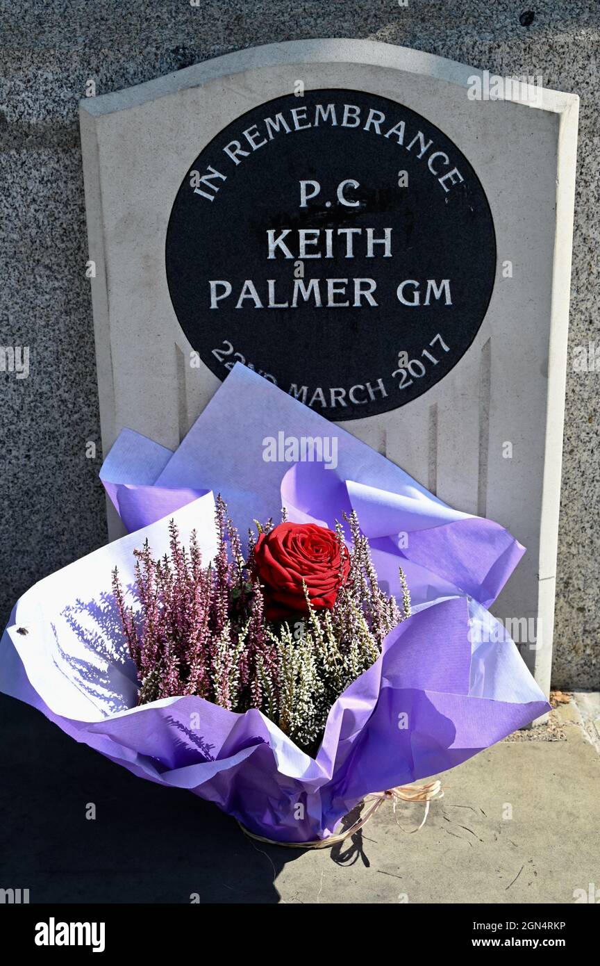London, UK. A floral tribute was left on the memorial to PC Keith Palmer who died on 22nd March 2017 and was posthumously awarded the George Medal, Houses of Parliament, Westminster. Stock Photo