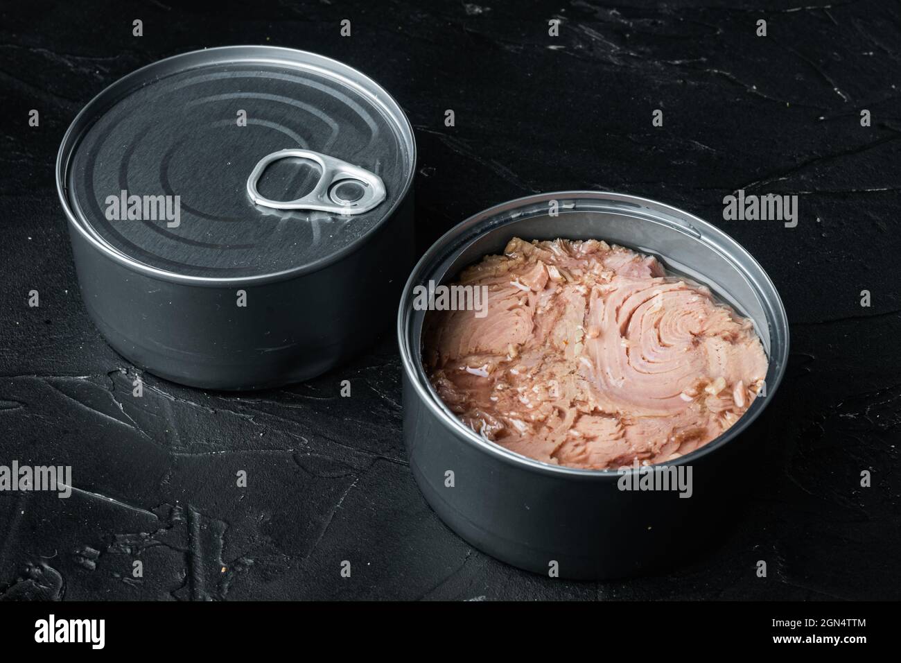 Canned Wild Yellowfin Tuna set, in tin can, on black background Stock