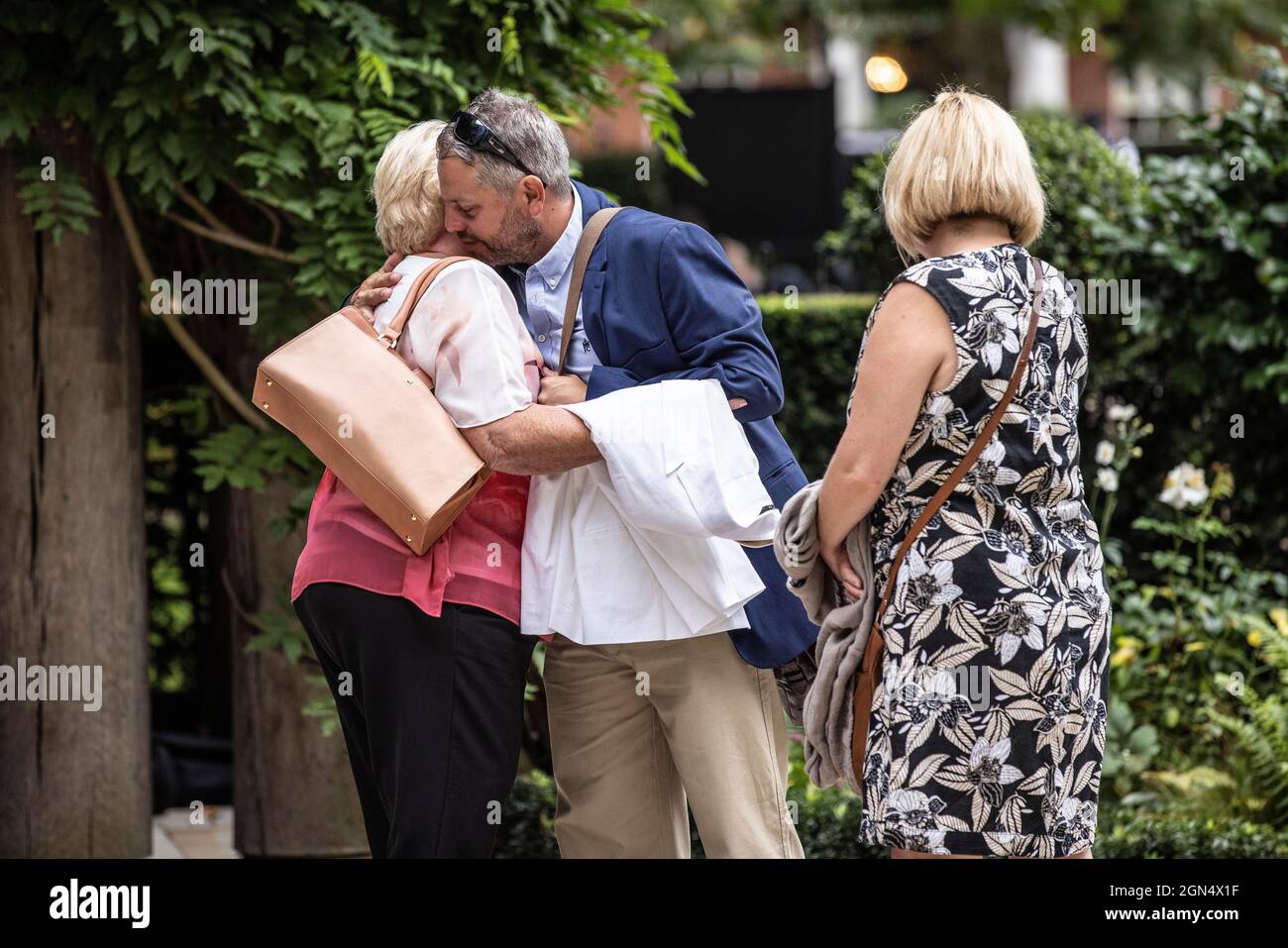 Families pay their respects at the September 11 Memorial Garden in London's Grosvenor Square on the 20th Anniversary of the 9/11 terrorist attacks. Stock Photo