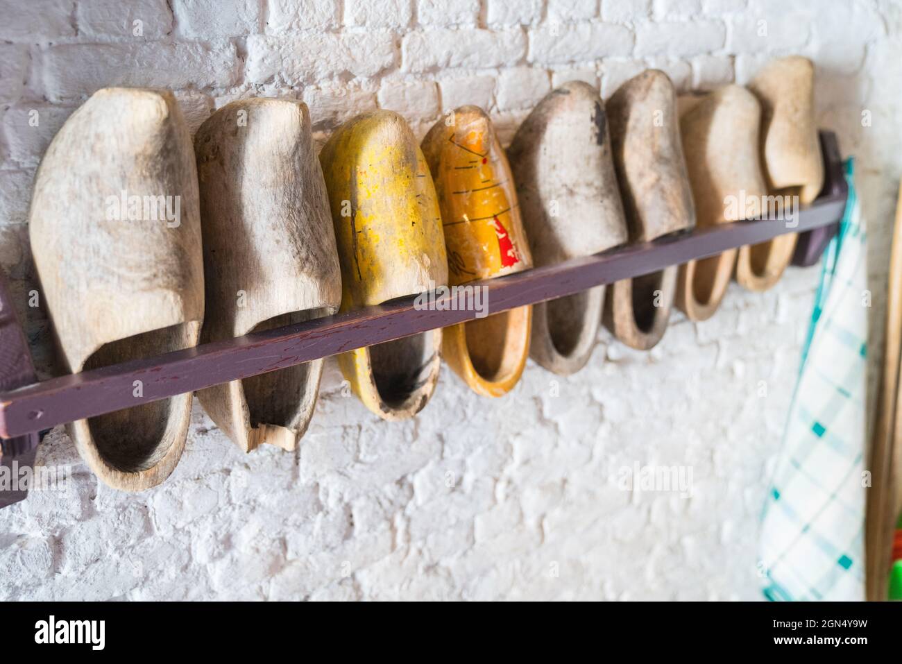 Rack of Dutch clogs on wall in selective focus in line Stock Photo