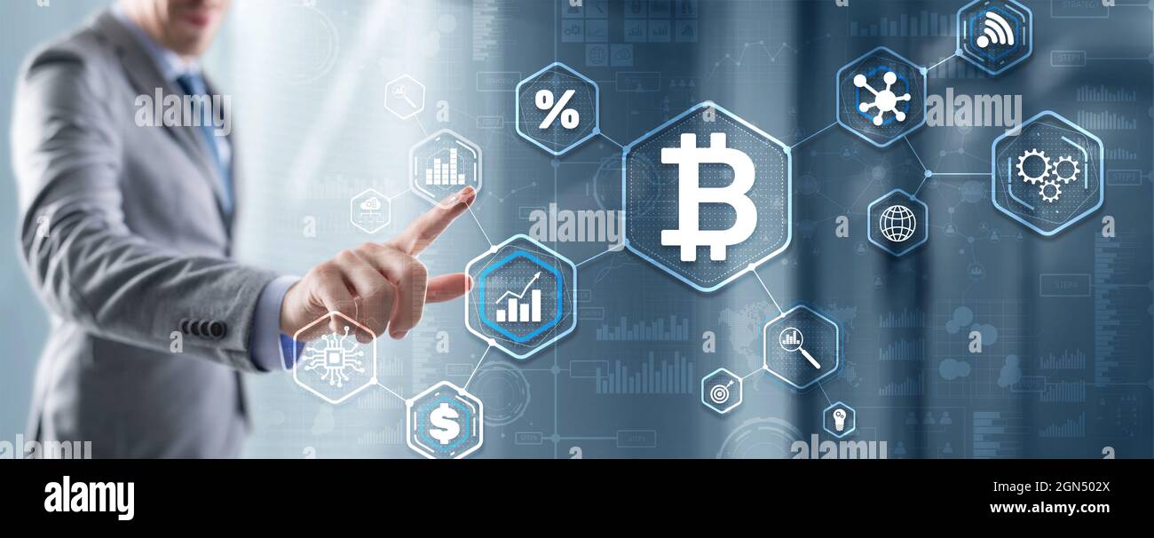 Man clicks on a virtual screen bitcoin icon. Stock Photo