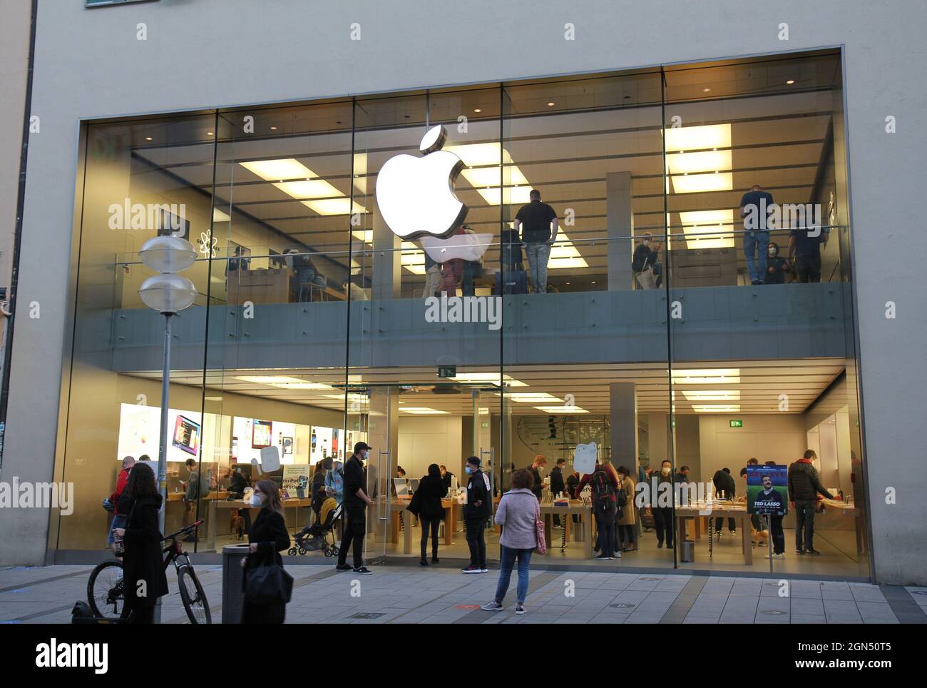 Apple store munich,  apple logo illuminated in the evening. Stock Photo