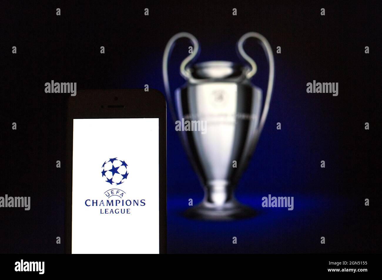 In this photo illustration the UEFA Champions League logo seen displayed on  a smartphone with the UEFA Champions League trophy in the background Stock  Photo - Alamy