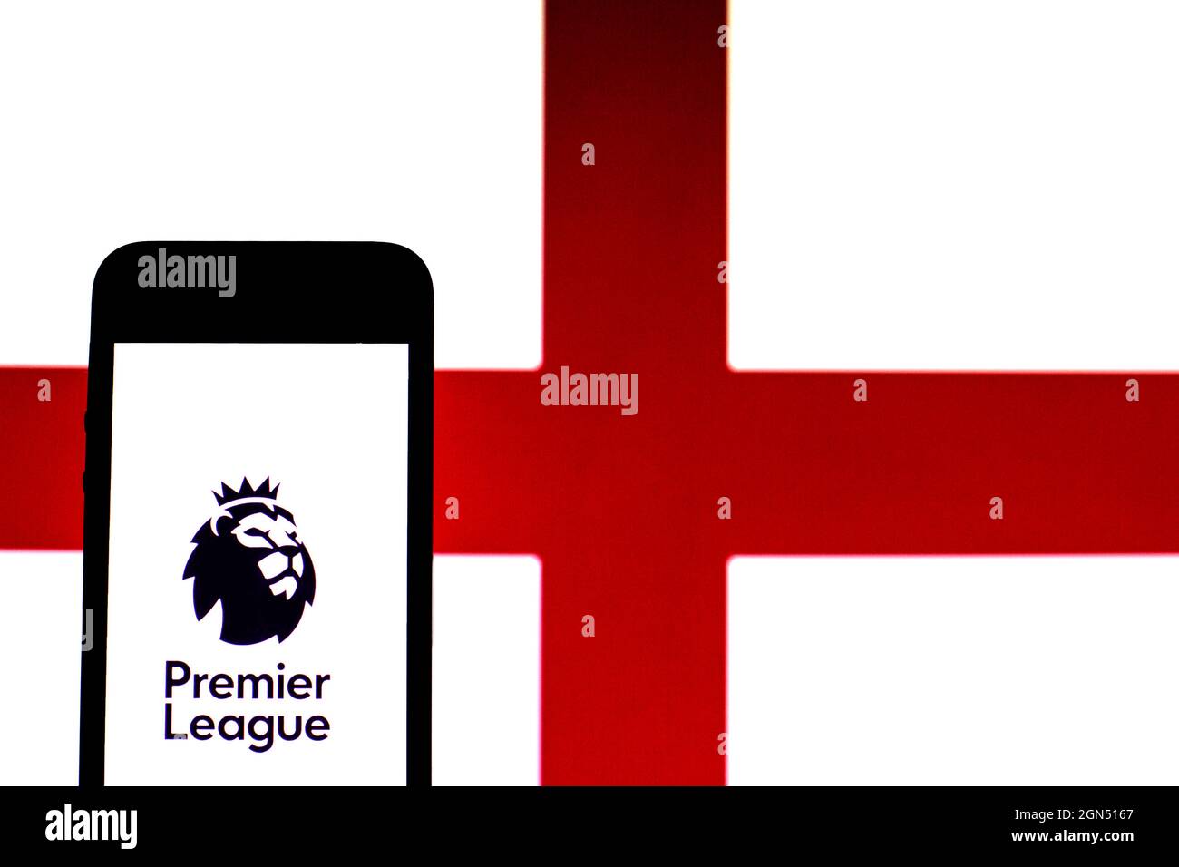 In this photo illustration a Premier League logo seen displayed on a smartphone with an England flag in the background. Stock Photo