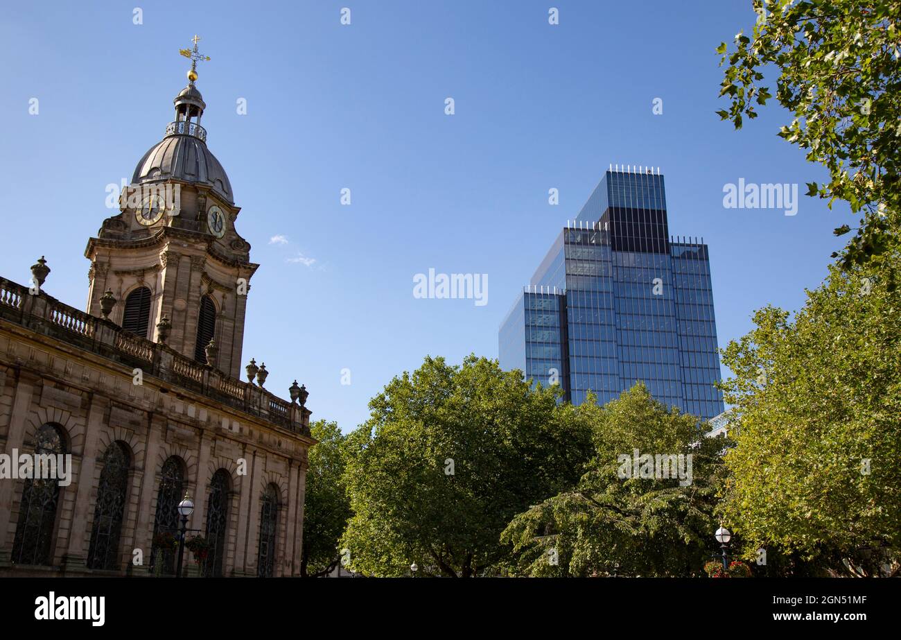 A newly built modern office tower block towers above the classical St Philips Cathedral in the centre of Birmingham, England. Stock Photo