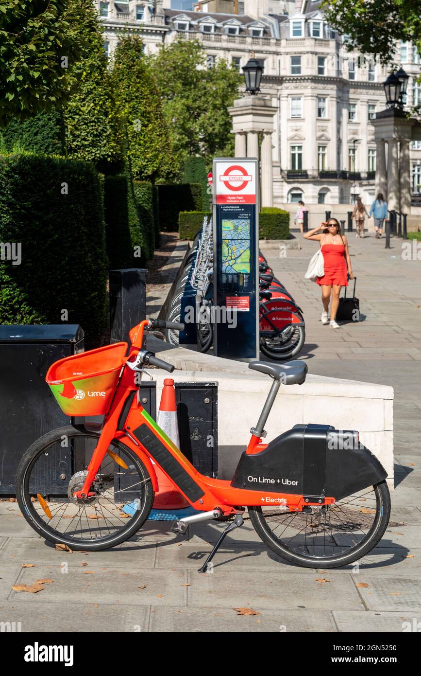 Lime electric bicycle for hire, by a Santander Cycles docking station
